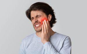 guy with tooth pain that needs emergency dental care